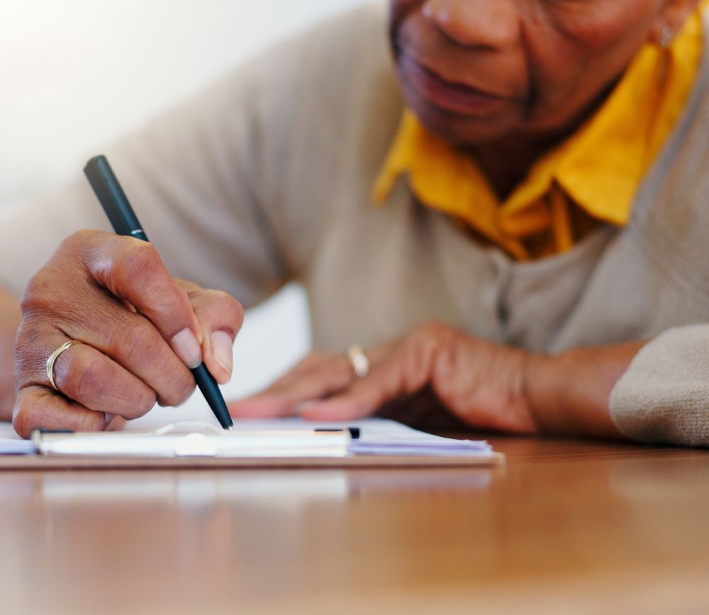 Close up of a woman filling out some forms