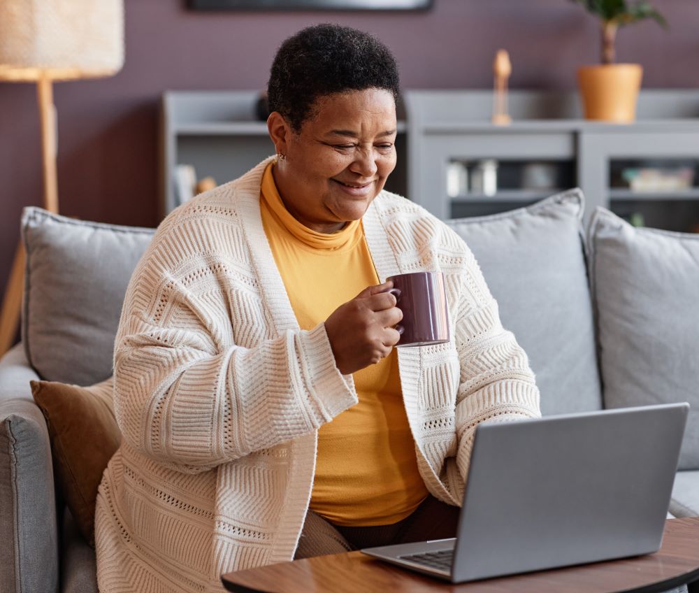 Woman smiling looking at laptop